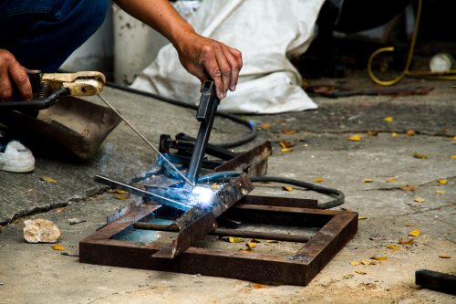 Workers are welding steel at the work.
